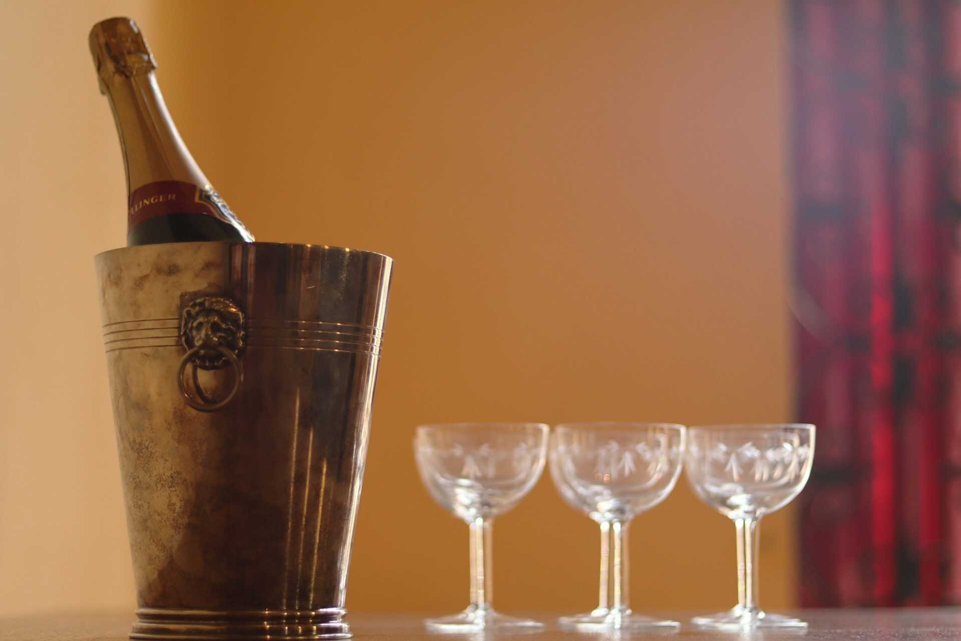 Champagne in metal cooler with glasses