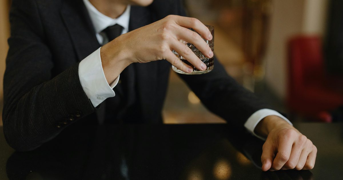 Businessman holding whisky glass