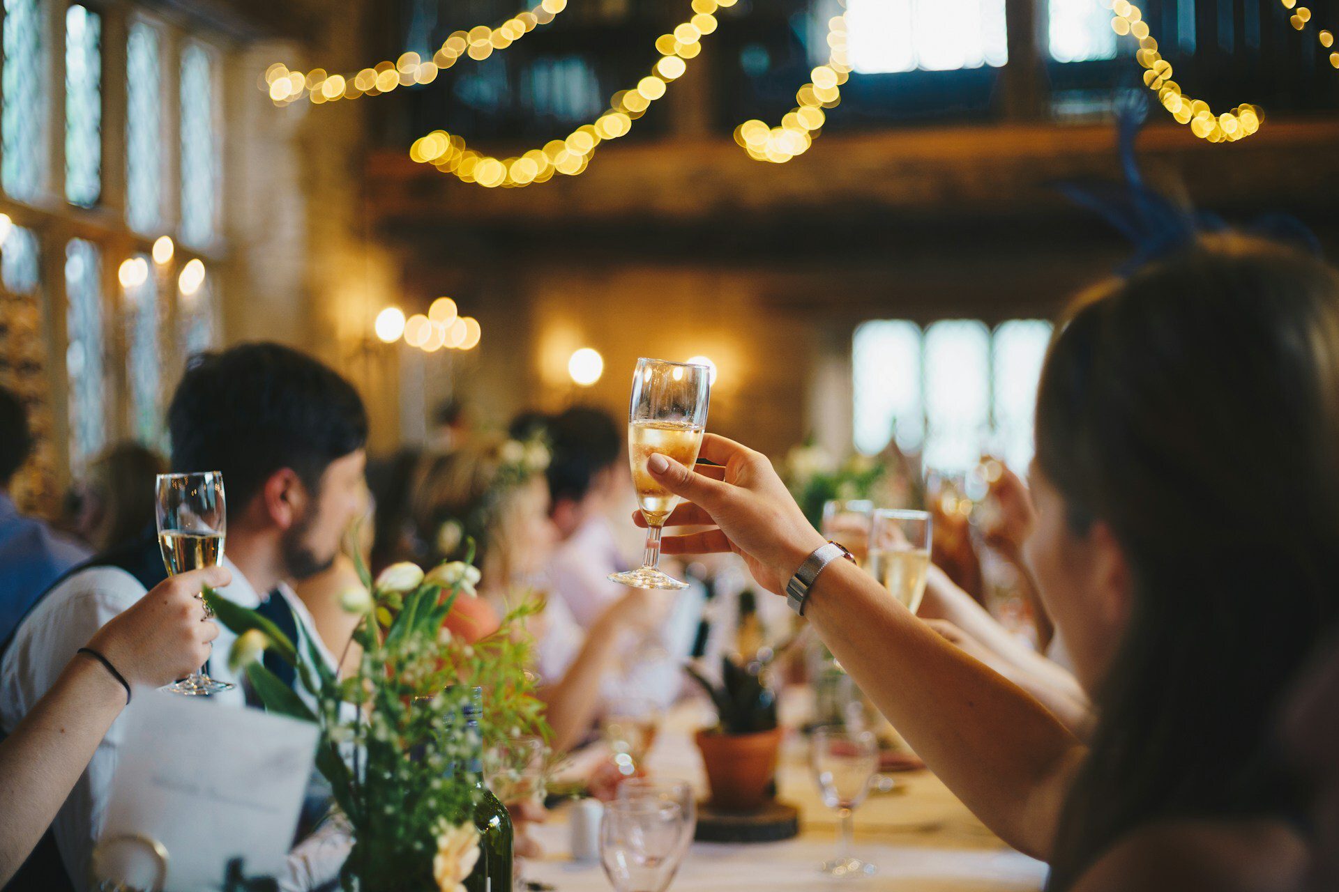 People toast with champagne glasses