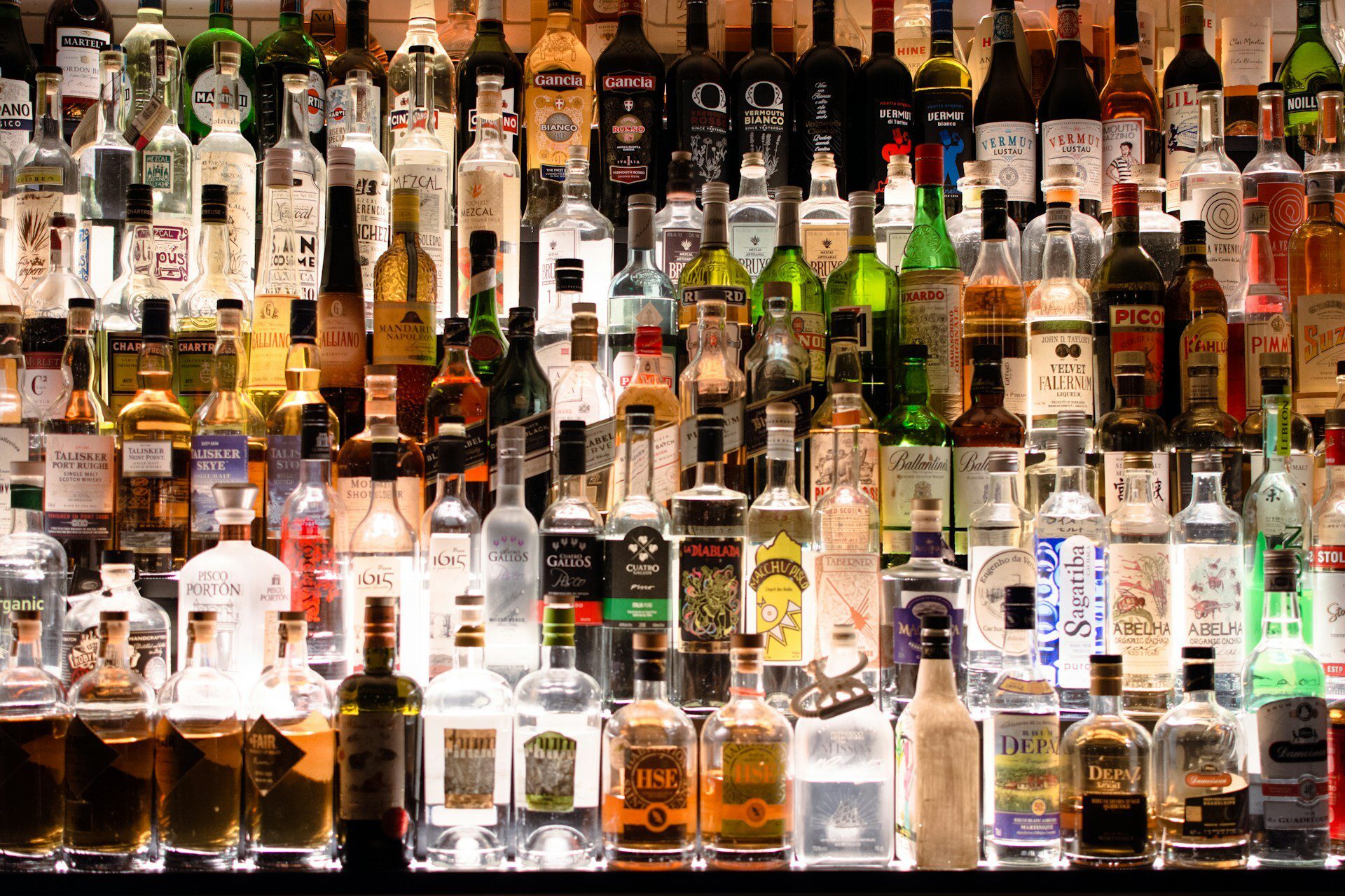 Rows of whisky bottles on shelves showing different brands